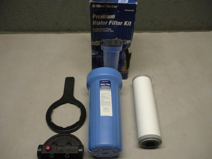 Camco West Marine premium water filter kit 13915137. Includes filter body, 5 micron cartridge, mounting bracket, hose barb fittings, extension hose and wrench. New old stock item in original packaging.